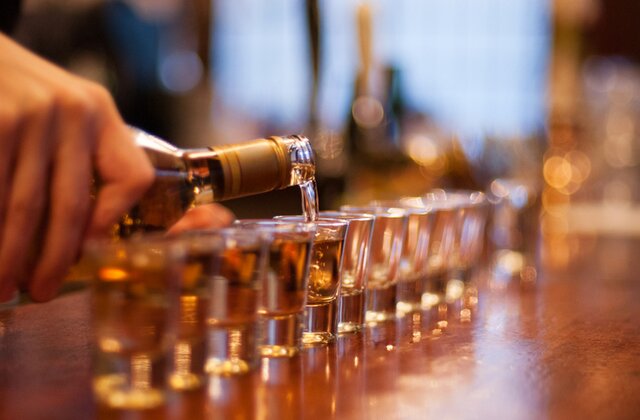 Bartender refilling multiple shots at a Louisiana bar highlighting underage drinking compliance risks and the need for forensic ID verification